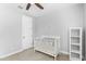 Neutral bedroom featuring a ceiling fan, a crib, and minimalist decor at 3818 E Appaloosa Rd, Gilbert, AZ 85296