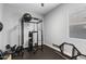 Bright, well-equipped home gym with rubber flooring, weight rack, and ceiling fan at 3818 E Appaloosa Rd, Gilbert, AZ 85296
