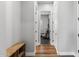 Hallway with wood flooring, a bench, and an open doorway to the home's gym at 3818 E Appaloosa Rd, Gilbert, AZ 85296