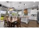Open kitchen and dining area featuring a large island, wooden table, and sliding doors to the backyard at 3818 E Appaloosa Rd, Gilbert, AZ 85296