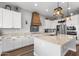 Spacious kitchen with white cabinets, stainless appliances, granite countertops, and a large island at 3818 E Appaloosa Rd, Gilbert, AZ 85296