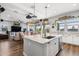 Open kitchen featuring a large island with stainless steel appliances and an adjacent dining and living area at 3818 E Appaloosa Rd, Gilbert, AZ 85296