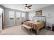 Spacious primary bedroom featuring three large windows, ceiling fan, and carpet floors at 3818 E Appaloosa Rd, Gilbert, AZ 85296