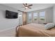 Spacious primary bedroom with a ceiling fan, three windows, and ensuite bathroom at 3818 E Appaloosa Rd, Gilbert, AZ 85296