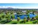 Community lake and pool with mountain views and lush landscaping throughout the neighborhood at 3837 E Santa Fe Ln, Gilbert, AZ 85297