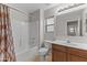 Bathroom featuring a shower-tub combo, vanity with sink, and a large mirror at 3837 E Santa Fe Ln, Gilbert, AZ 85297