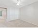 Bedroom with neutral walls, carpeted floor, closet with white sliding doors and a ceiling fan at 3837 E Santa Fe Ln, Gilbert, AZ 85297
