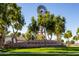 Power Ranch community entrance with a windmill on a manicured lawn under a blue sky at 3837 E Santa Fe Ln, Gilbert, AZ 85297