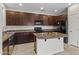 Modern kitchen with dark cabinets, granite countertops, and stainless steel appliances at 3837 E Santa Fe Ln, Gilbert, AZ 85297
