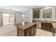 Open kitchen layout featuring a kitchen island and view of the dining and living areas at 3837 E Santa Fe Ln, Gilbert, AZ 85297