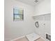 Bright laundry room with washer/dryer hookups and a window providing natural light at 3837 E Santa Fe Ln, Gilbert, AZ 85297