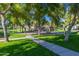 Neighborhood playground in a green space featuring trees and a paved walking path at 3837 E Santa Fe Ln, Gilbert, AZ 85297