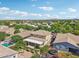 A neighborhood aerial shot shows backyards, pools, lush trees, and houses under a bright blue sky at 4109 E Sierra Madre Ave, Gilbert, AZ 85296