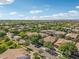 Aerial photo showing a dense neighborhood with mature trees. Mountains can be seen in the distance at 4109 E Sierra Madre Ave, Gilbert, AZ 85296