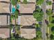 Aerial view of residences showcases a neighborhood with pools, mature trees, and well-maintained streets at 4109 E Sierra Madre Ave, Gilbert, AZ 85296