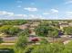 Aerial view of a two-story home in a neighborhood filled with mature trees and green lawns on a sunny day at 4109 E Sierra Madre Ave, Gilbert, AZ 85296