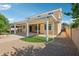 Backyard features an extended covered patio, gravel, turf, and mature landscaping at 4109 E Sierra Madre Ave, Gilbert, AZ 85296