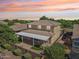 Aerial view of backyard featuring covered patio, artificial turf, manicured landscaping, and privacy wall at 4109 E Sierra Madre Ave, Gilbert, AZ 85296