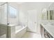 Bright bathroom featuring a soaking tub and separate shower at 4109 E Sierra Madre Ave, Gilbert, AZ 85296