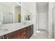 Bathroom with double sinks, granite counters, and a glass shower at 4109 E Sierra Madre Ave, Gilbert, AZ 85296