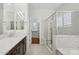 Bathroom features double vanity, marble countertops, walk-in shower and view to walk-in closet at 4109 E Sierra Madre Ave, Gilbert, AZ 85296