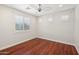 Bedroom with hardwood floors, a ceiling fan, and a view of the outdoors at 4109 E Sierra Madre Ave, Gilbert, AZ 85296