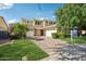 Charming two-story home featuring a paver driveway, lush landscaping, and a three-car garage at 4109 E Sierra Madre Ave, Gilbert, AZ 85296