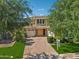 Two-story home with brick accents, lush landscaping and paver driveway at 4109 E Sierra Madre Ave, Gilbert, AZ 85296