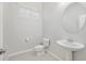 Well lit half bath with a pedestal sink, and decorative mirror and lighting at 4109 E Sierra Madre Ave, Gilbert, AZ 85296