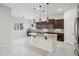 Spacious kitchen with dark wood cabinets, stainless steel appliances, and an island at 4109 E Sierra Madre Ave, Gilbert, AZ 85296