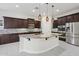 Modern kitchen featuring a large island, stainless steel appliances, and custom cabinetry at 4109 E Sierra Madre Ave, Gilbert, AZ 85296