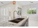 Close-up view of the kitchen island featuring a stainless steel faucet and granite countertop at 4109 E Sierra Madre Ave, Gilbert, AZ 85296