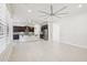 Open-concept living room and kitchen featuring tile flooring, a modern ceiling fan, and ample natural light at 4109 E Sierra Madre Ave, Gilbert, AZ 85296