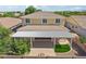 Shot of the home's back yard with a covered patio, artificial turf, retaining wall and fire pit feature at 4109 E Sierra Madre Ave, Gilbert, AZ 85296