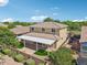 The back of the house shows a covered patio, a small patch of synthetic grass, and a brick retaining wall at 4109 E Sierra Madre Ave, Gilbert, AZ 85296
