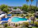 Aerial view of community pool area with blue umbrellas, mature trees, and lush landscaping at 4228 N 81St St, Scottsdale, AZ 85251