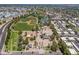 A high-angle shot displays a well-planned residential area next to a sports complex, complete with green fields and tennis courts at 4228 N 81St St, Scottsdale, AZ 85251