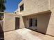 Exterior patio with sliding glass door that leads to interior and door to storage unit at 4228 N 81St St, Scottsdale, AZ 85251