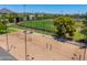 Aerial view of a baseball field and sand volleyball court with sports lighting, manicured landscape and trees at 4228 N 81St St, Scottsdale, AZ 85251