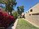 Well-manicured community green space featuring mature trees, flowering bushes, and neatly trimmed lawns at 4228 N 81St St, Scottsdale, AZ 85251