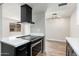 Kitchen featuring a black vent hood and modern electric range oven at 4228 N 81St St, Scottsdale, AZ 85251