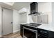 Modern kitchen featuring a black oven, white countertops, cabinets, and a stylish vent hood at 4228 N 81St St, Scottsdale, AZ 85251
