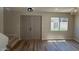 Living room featuring hardwood floors, double door entry, and bright window at 4228 N 81St St, Scottsdale, AZ 85251