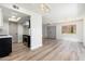 Spacious living area with hardwood flooring, a skylight, and seamless connection to the modern kitchen at 4228 N 81St St, Scottsdale, AZ 85251