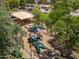 An aerial view shows a colorful playground with slides and play structures, nestled among mature trees and picnic spots at 4228 N 81St St, Scottsdale, AZ 85251