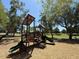 Community playground nestled under mature trees, with slides and climbing structures for fun and recreation at 4228 N 81St St, Scottsdale, AZ 85251