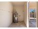 Utility room featuring a gray hot water heater and access to the home's back patio at 4228 N 81St St, Scottsdale, AZ 85251