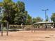 Outdoor sand volleyball court with lights and covered picnic area under a clear, blue sky at 4228 N 81St St, Scottsdale, AZ 85251