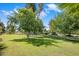 A sprawling lawn is framed by mature trees, with ample room to relax at 502 W Port Royale Ln, Phoenix, AZ 85023