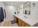 Updated bathroom features a dual sink vanity with a white quartz countertop and stylish mirrors at 502 W Port Royale Ln, Phoenix, AZ 85023